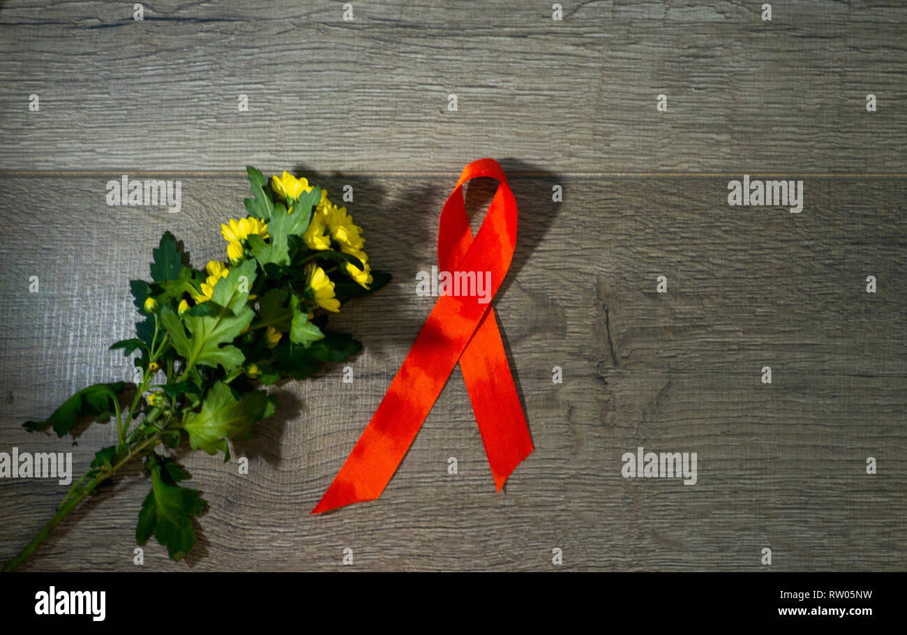 Red ribbon awareness on old aged wood background: World aids day ...