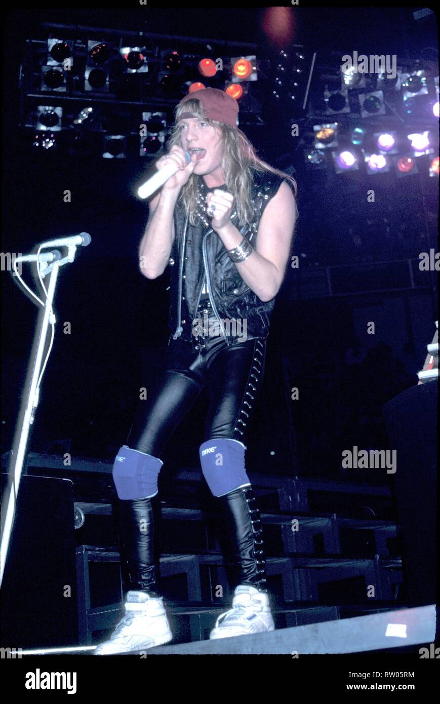 Singer Jani Lane of the hard rock band Warrant is shown performing on stage during a "live