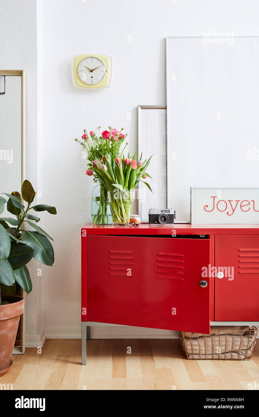 vivid interior flowers and red cabinet with happy sign Stock Photo