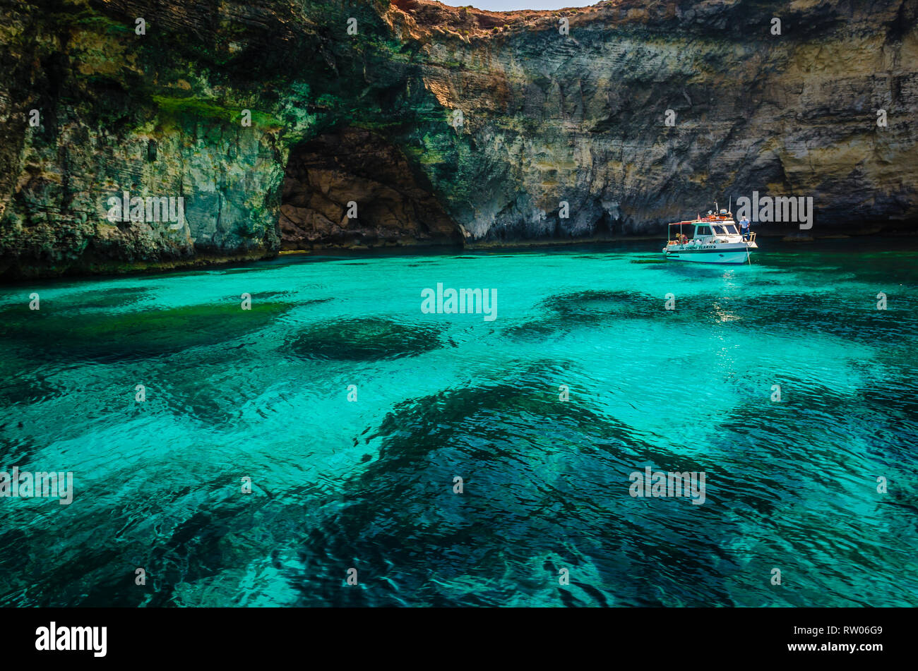 Blue Lagoon, Malta - the caves of the Blue Lagoon on the island of Comino on a bright sunny summer day with blue sky Stock Photo