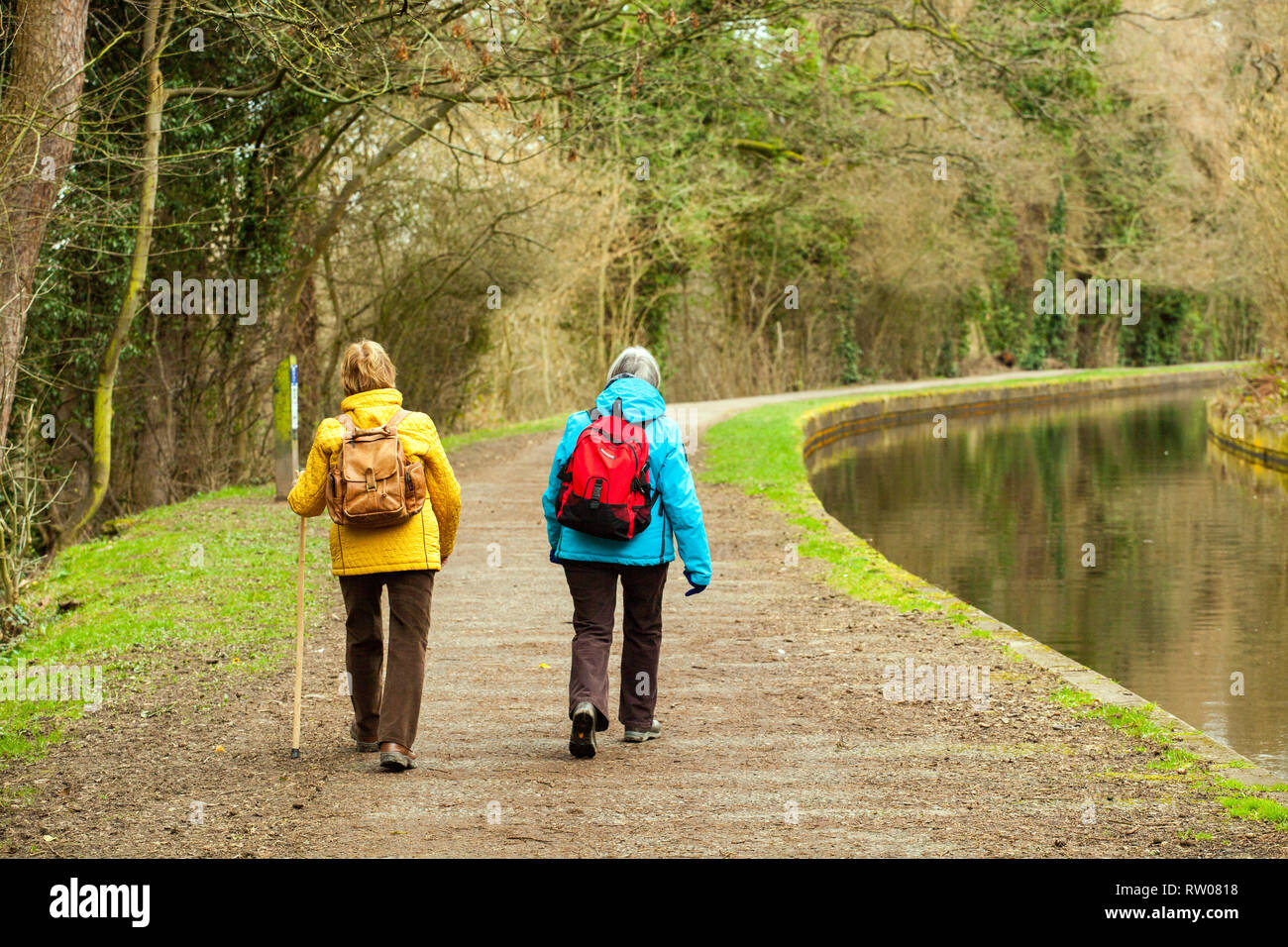 Walk With Rucksack Two women wearing rucksack backpack walking along the Llangollen canal ...