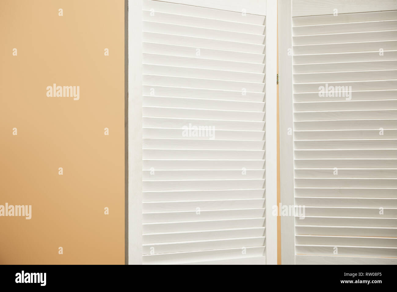 wooden room divider on beige background with copy space Stock Photo - Alamy