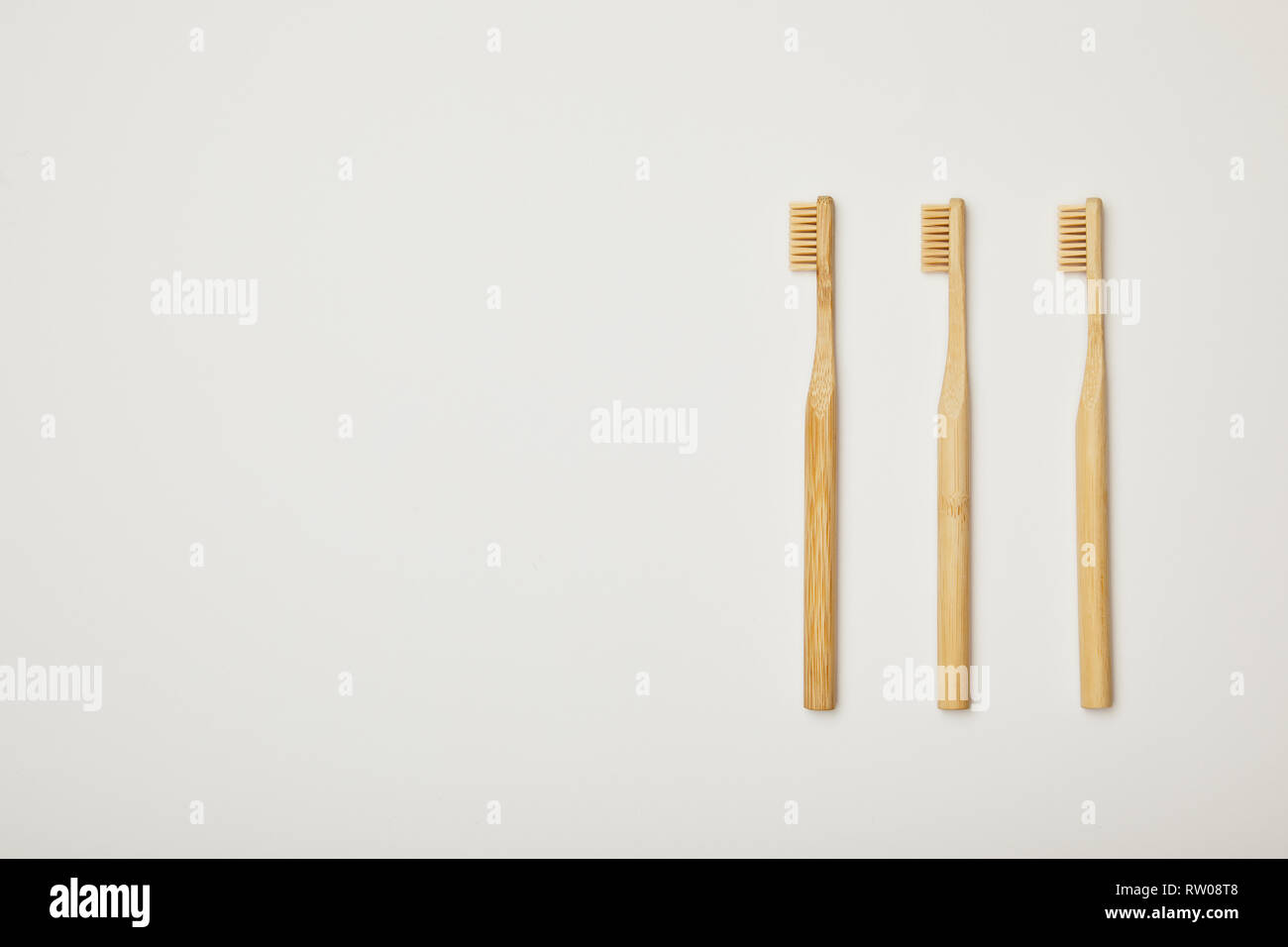 top view of bamboo brown toothbrushes on white background Stock Photo ...