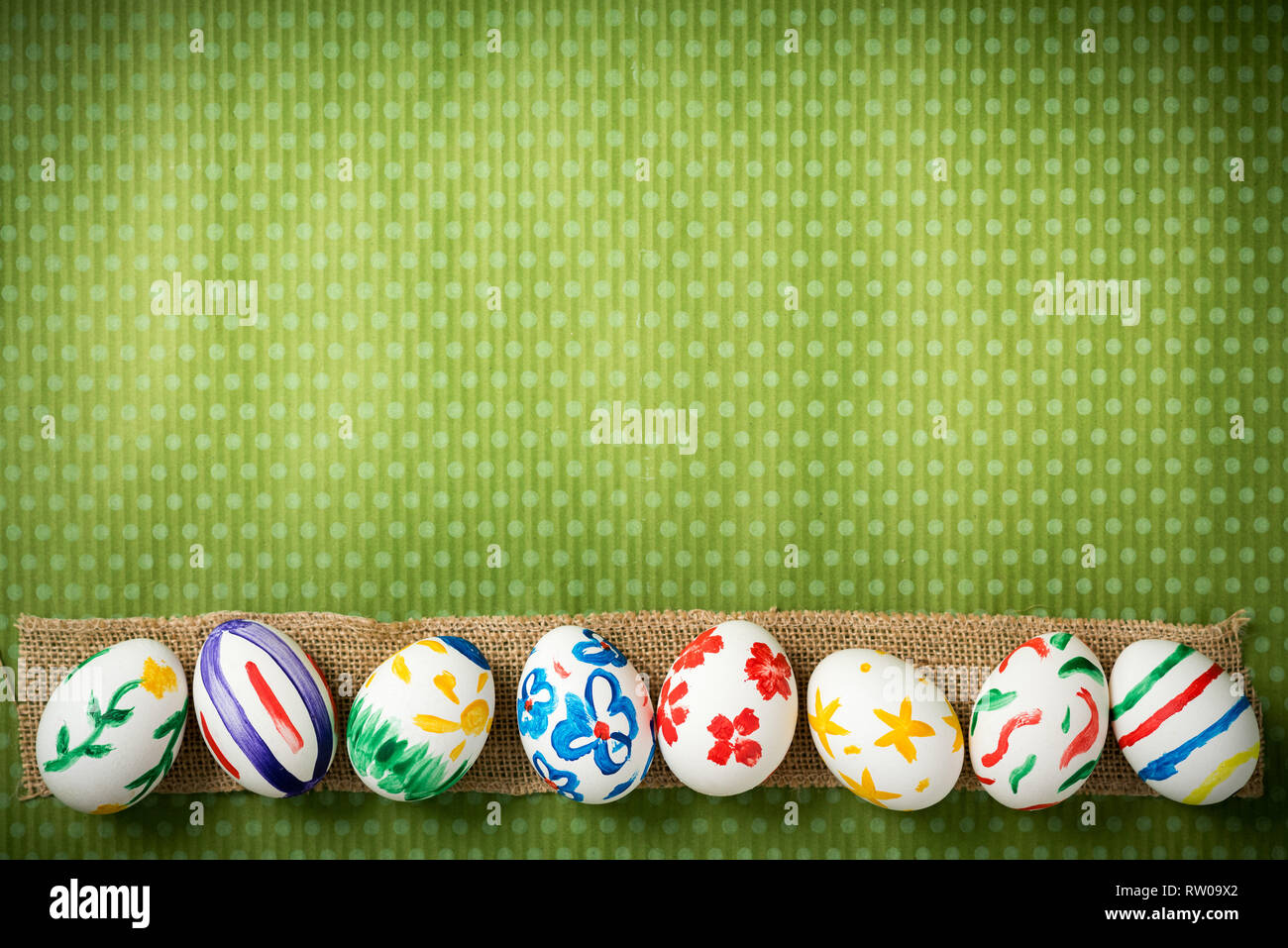 Easter eggs painted by hand on a beautiful green background in white peas. Festive background. Easter ideas. Space for text. Happy easter. Stock Photo