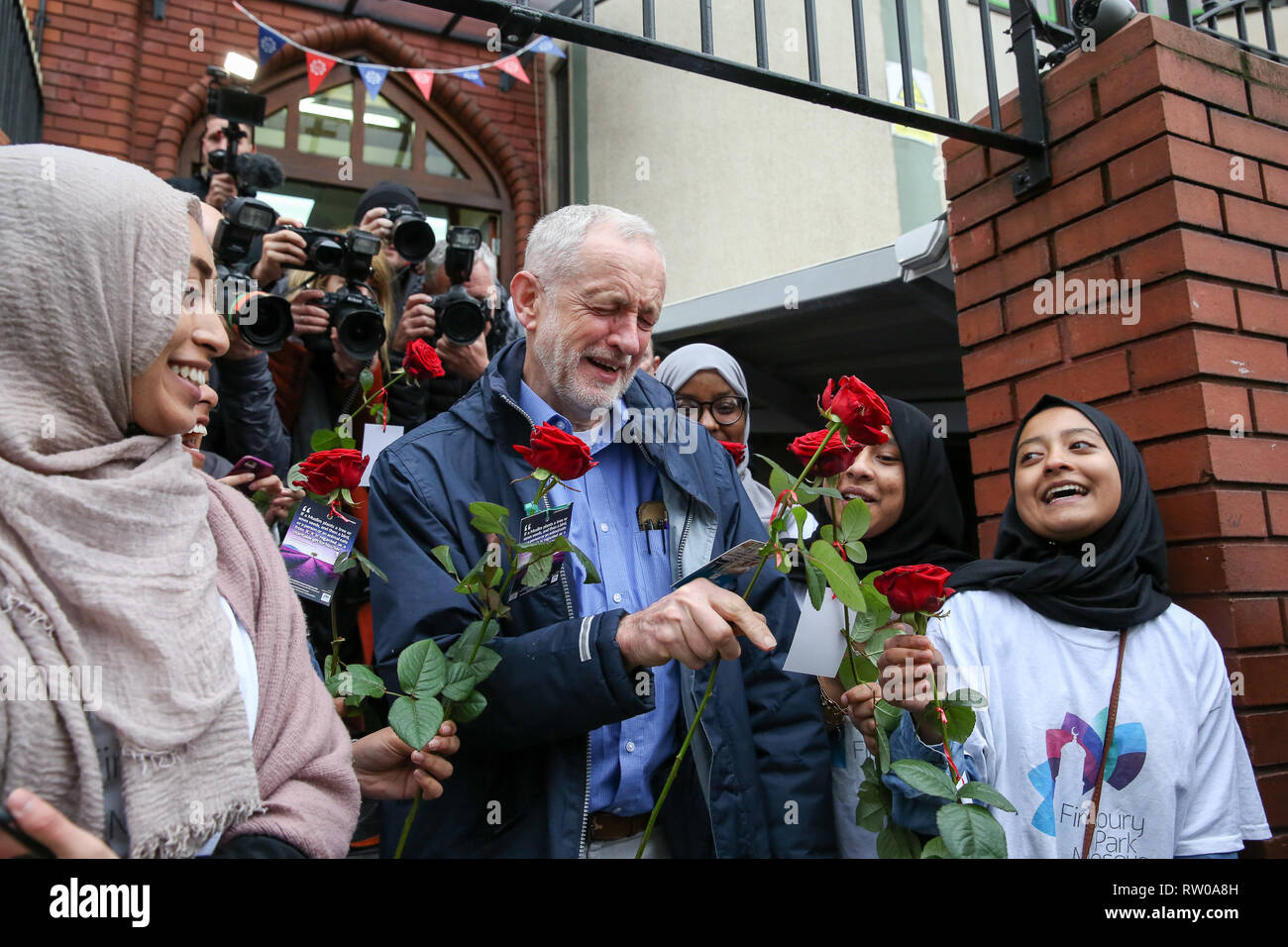 Labour leader Jeremy Corbyn is seen with flowers during the fourth Visit My Mosque Day at Finsbury Park Mosque in North London. Over 250 mosques open their doors to non-Muslim guests and visitors on the fourth Visit My Mosque Day. This year the national event also encourages mosques to support Keep Britain Tidy's Great British Spring Clean campaign with many already taking part in cleaning their communities. Later a man thought to be a pro-Brexit campaigner was arrested after he pressed down an egg on Jeremy Corbyn’s head. Stock Photo