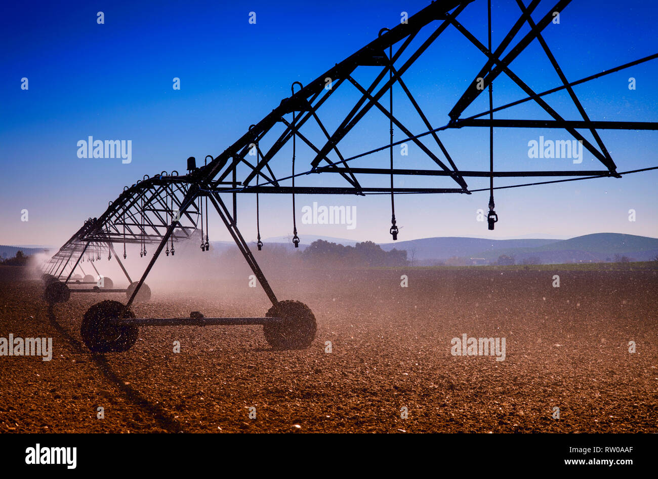 An overhead sprinkler water irrigation system  near Cordoba, Andalucia, Spain Stock Photo