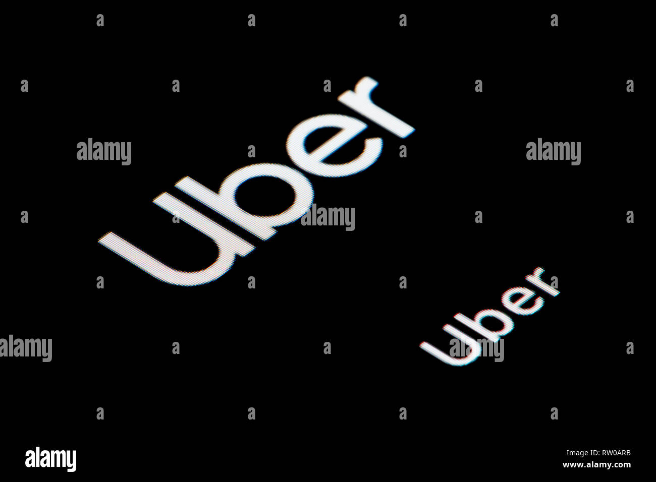 A close-up shot of the Uber app icon, as seen on the screen of a smart phone (Editorial use only) Stock Photo