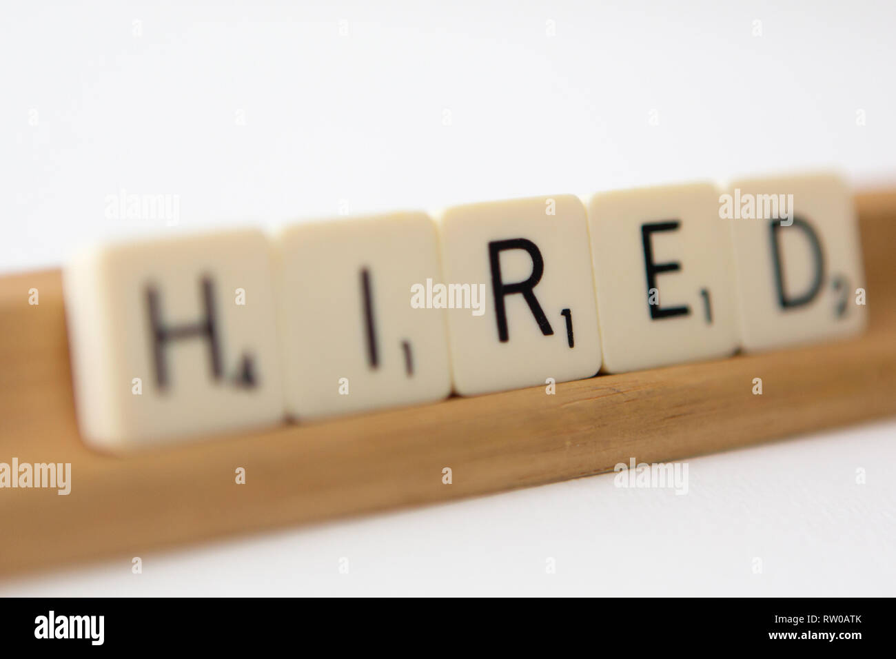 Tiles spell out the word 'hired' Stock Photo