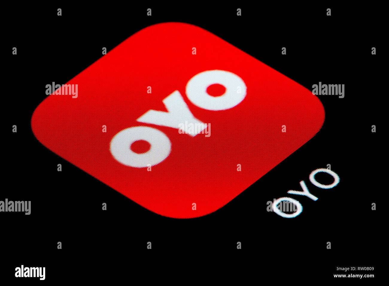 A close-up shot of the Oyo Rooms app icon, as seen on the screen of a smart phone (Editorial use only) Stock Photo