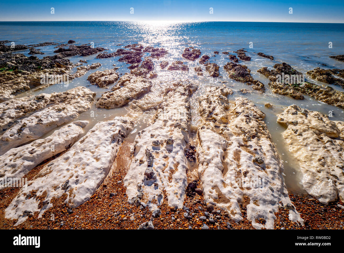 Sea water flows over white chalk rocks at the English South coast Stock ...