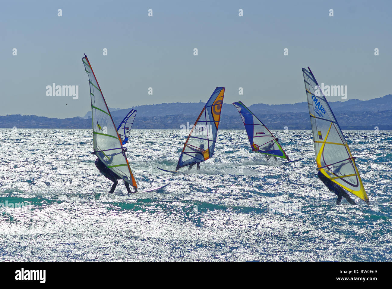 Windsurfers racing in the wind during a windy day Stock Photo