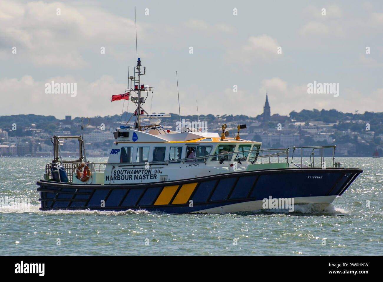 The Southampton Harbour Master launch 'Spitfire' heading for Portsmouth Harbour, UK with Ryde (Isle of Wight) in the background on 16/7/14. Stock Photo