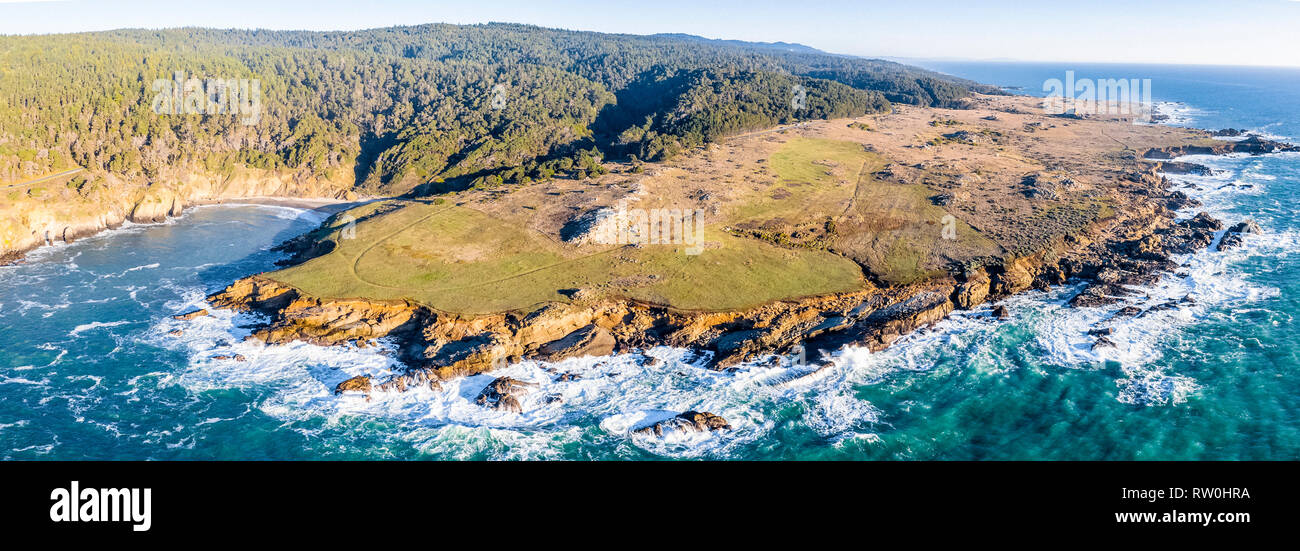 The cold waters of the Pacific Ocean, crashing against the rocky