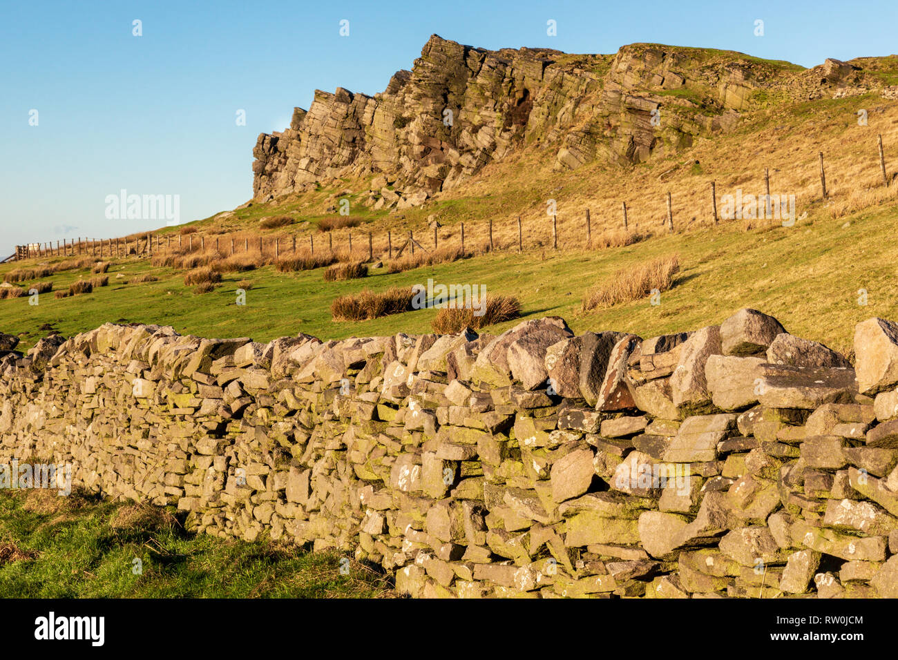 Windgather Rocks near Kettleshulme in the Derbyshire Peak District is a very popular climbing venue.  The sun is setting on the rocks. Stock Photo
