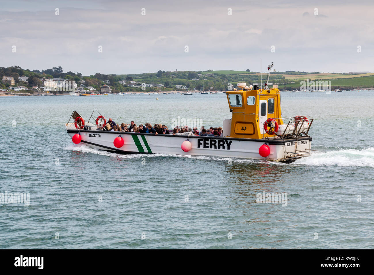 Padstow to Rock ferry boat filled with passengers crossing the Camel estuary towards Rock Stock Photo