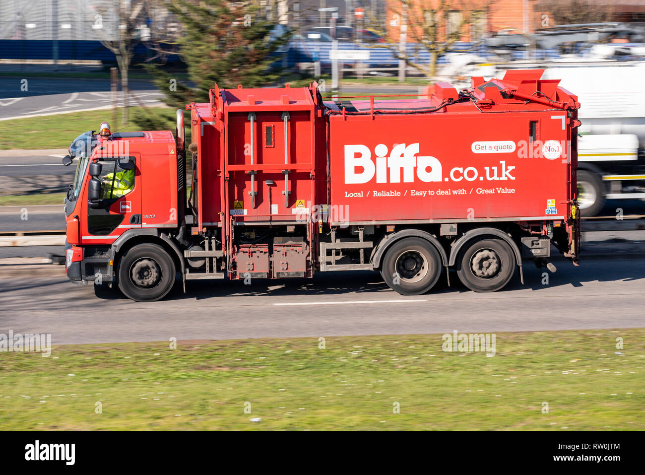 Biffa business waste rubbish collection vehicle, lorry, truck driving on the road. Refuse truck, bin lorry Stock Photo
