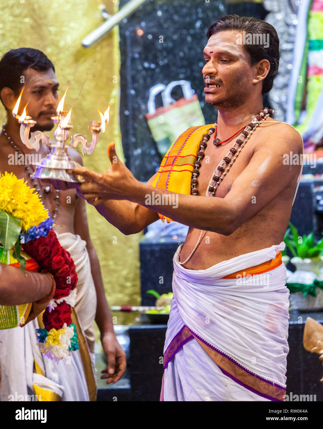 Batu Caves, Hindu Priest Performing Ritual, Selangor, Malaysia. Stock Photo