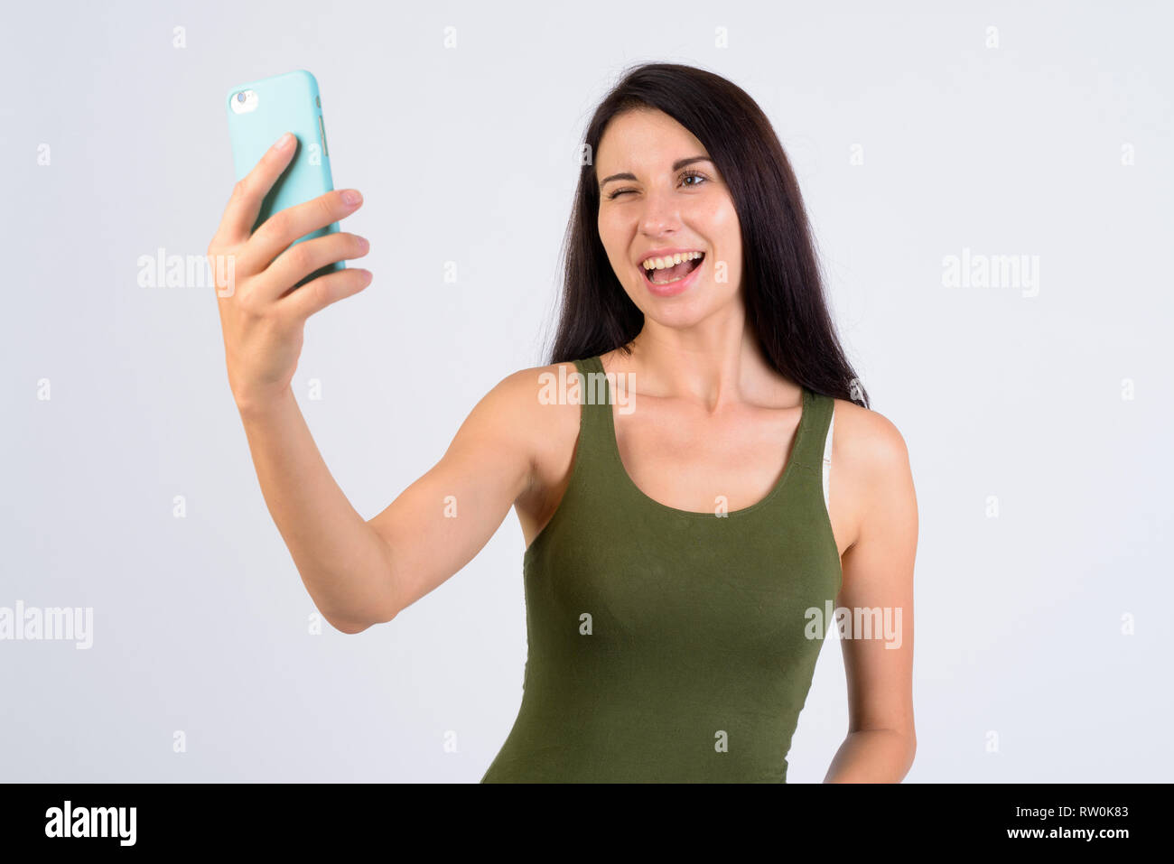 Portrait of happy young beautiful woman winking and taking selfie Stock ...