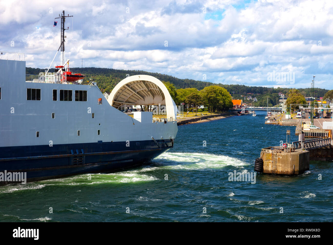 Ferry boat with its door open maneuvers in the port of Moss, Norway. Stock Photo