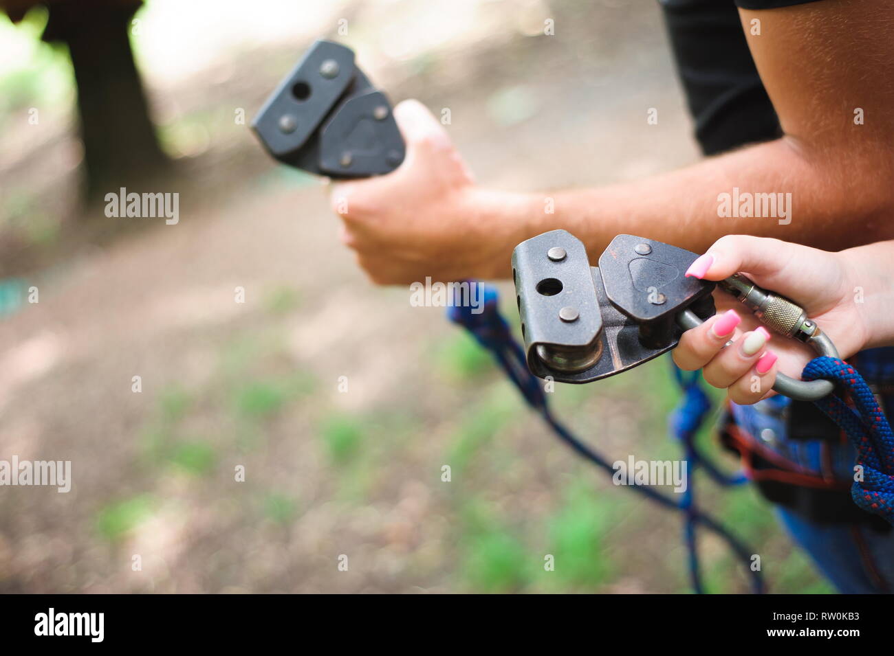 Hiking in the rope park two young people Stock Photo Alamy