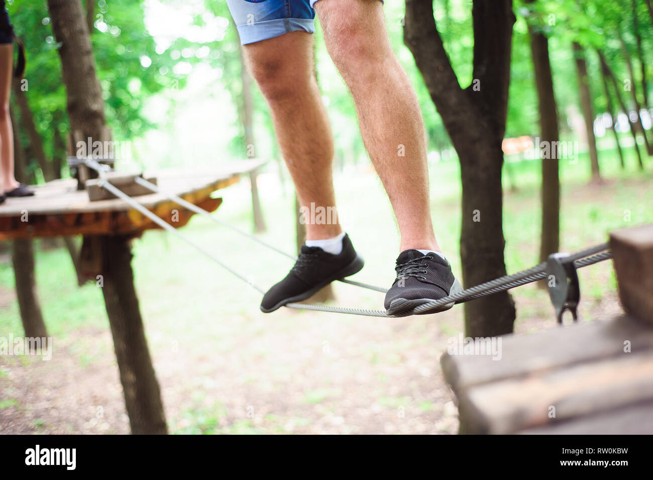Hiking in the rope park beautiful sports guy Stock Photo Alamy