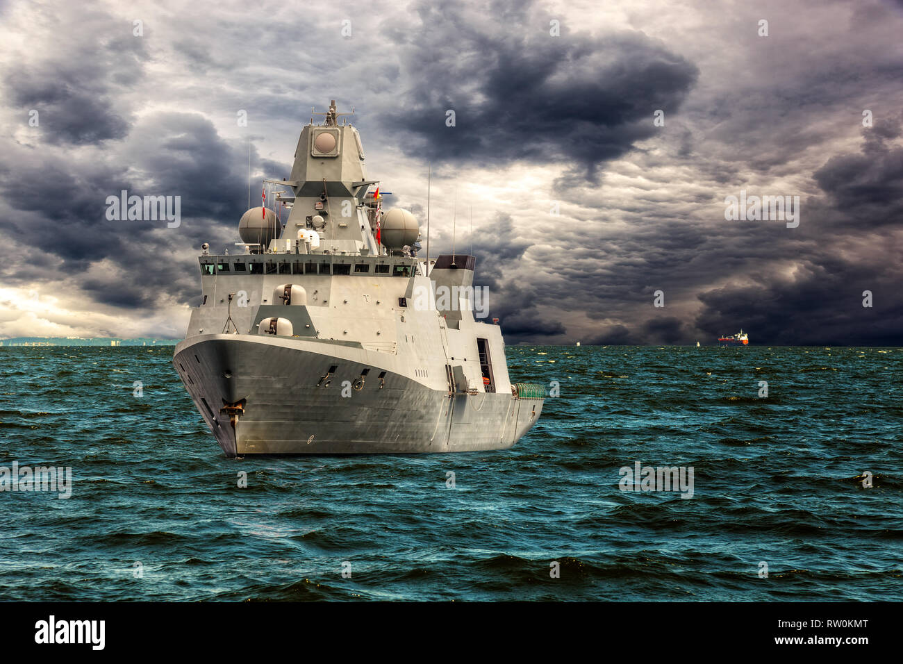 Warship on sea of dramatic scenery. Stock Photo