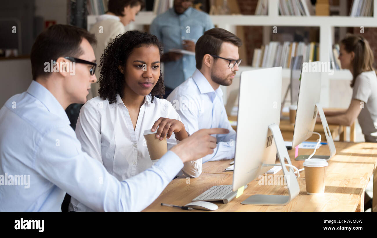 Multiracial people working in coworking office, mentor teach trainee Stock Photo
