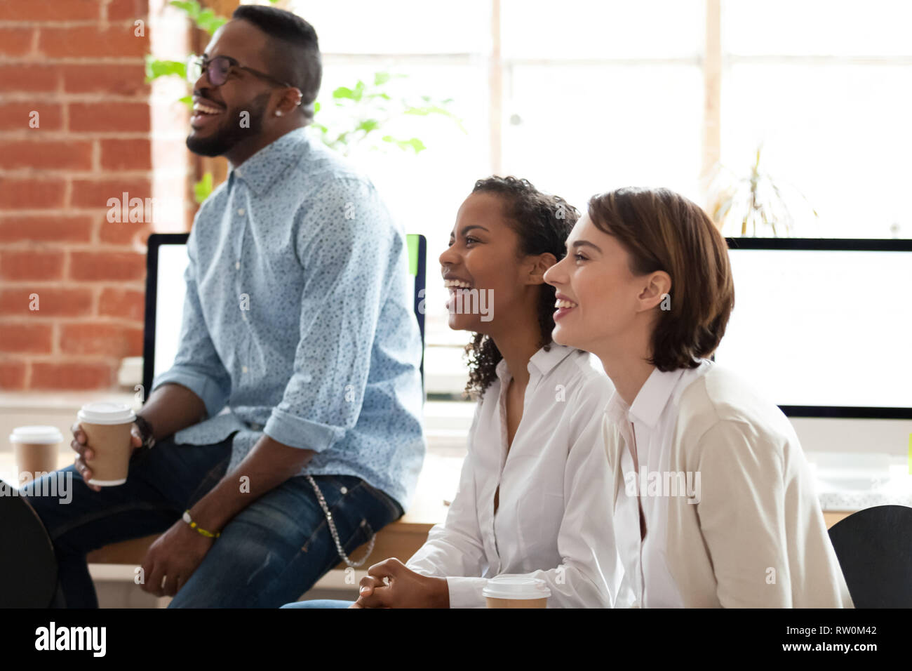 Diverse employees listening coach laughing during project presentation Stock Photo