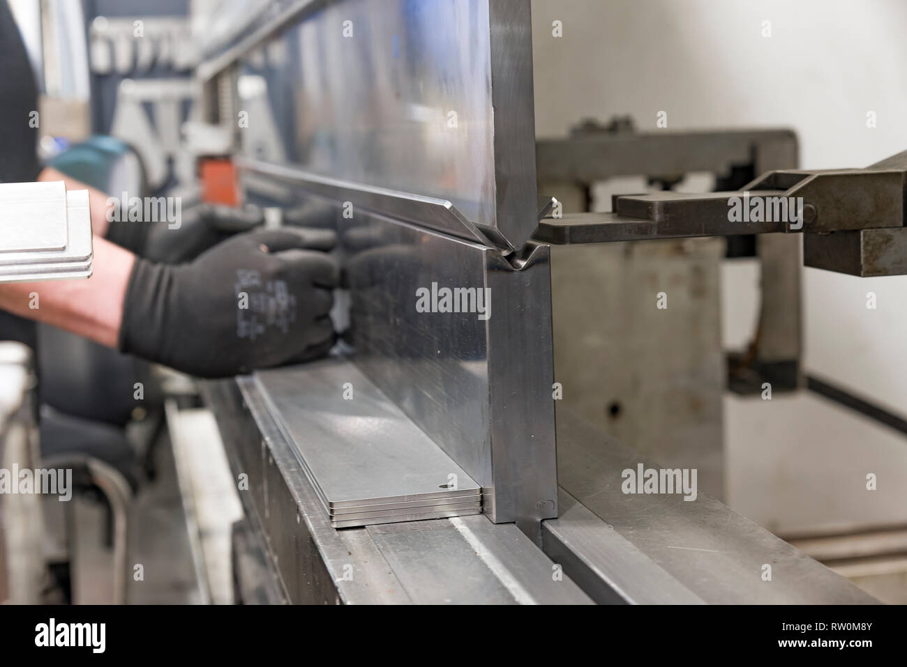 operator bending metal sheet by sheet bending machine bending of metal ...