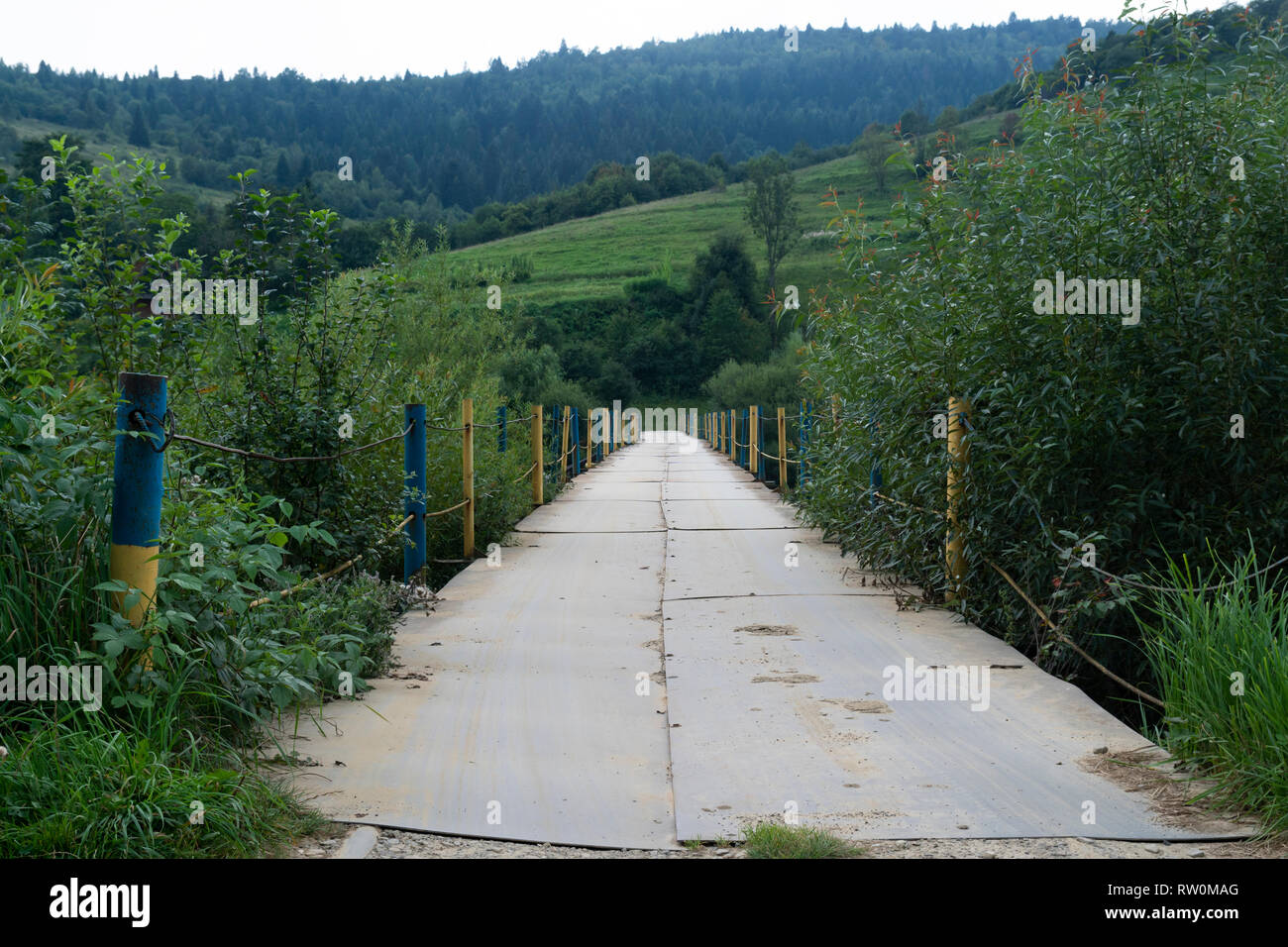 Old metall bridge on the river Stryi near Yasenytsya village Stock Photo