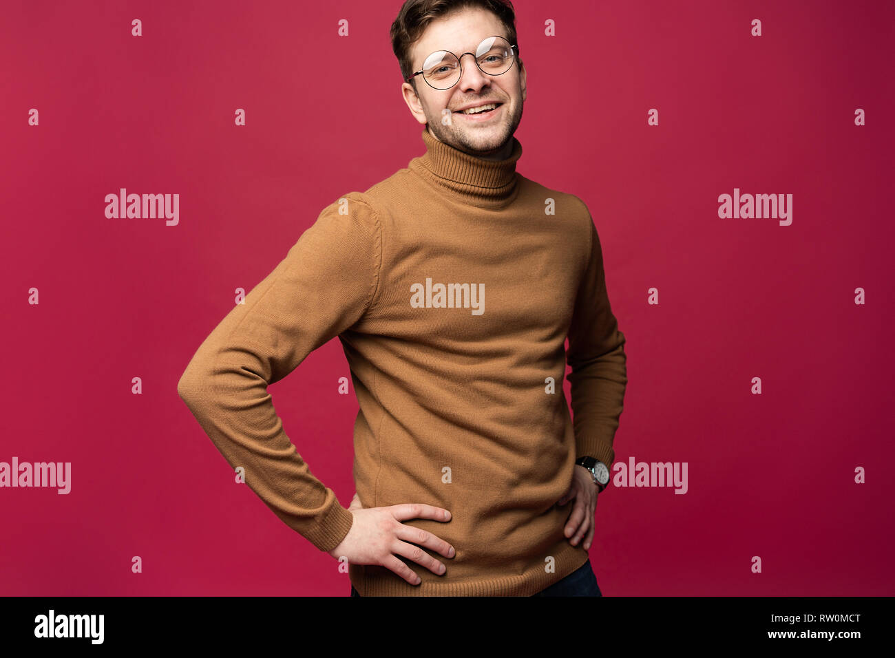 A confident young man in a studio, wearing glasses Stock Photo - Alamy