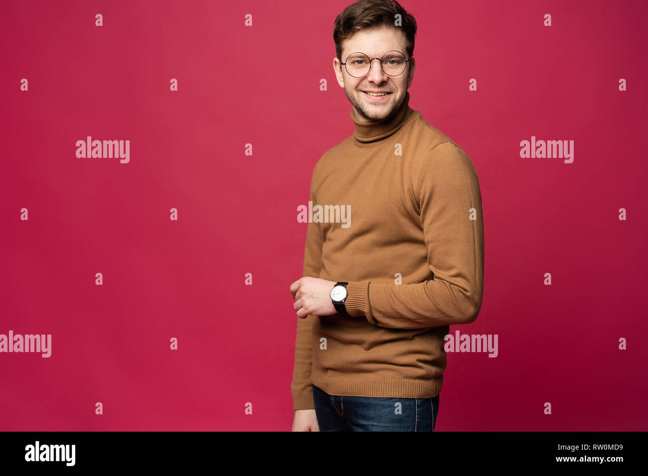 A confident young man in a studio, wearing glasses Stock Photo - Alamy