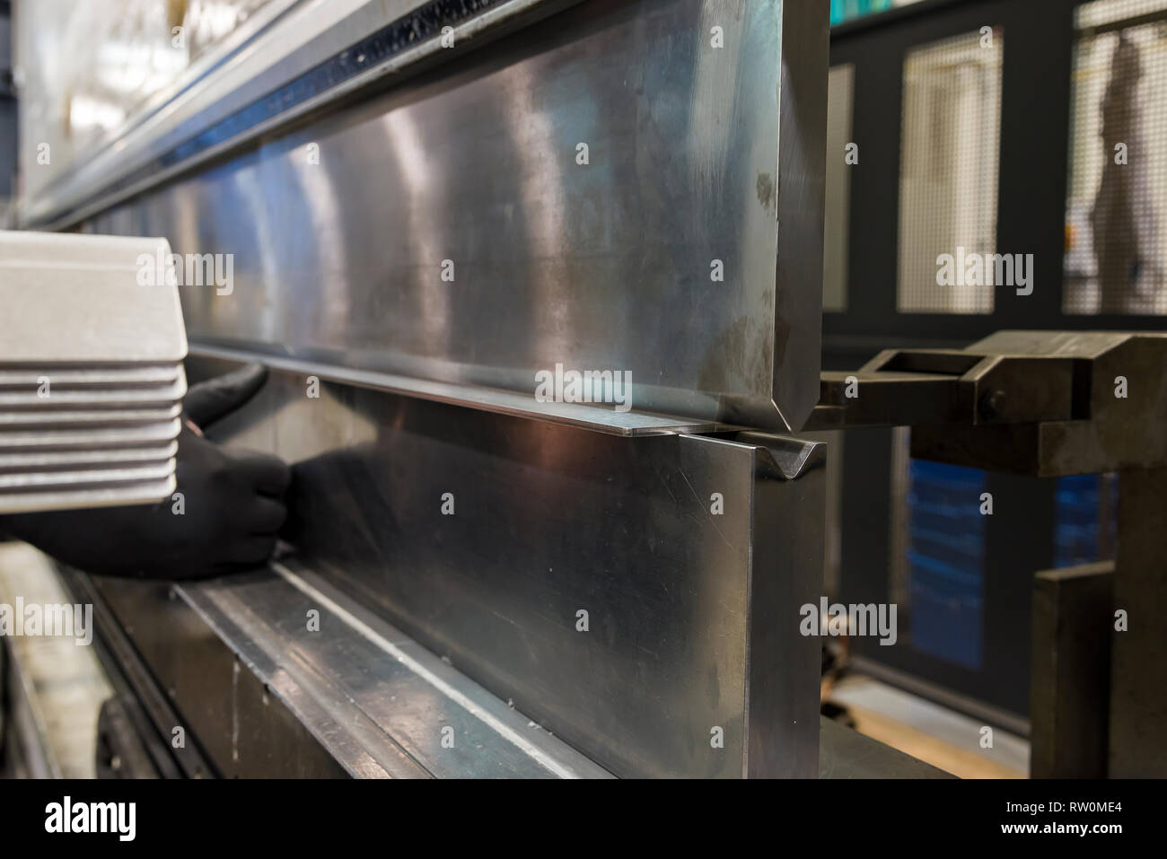 operator bending metal sheet by sheet bending machine bending of metal ...