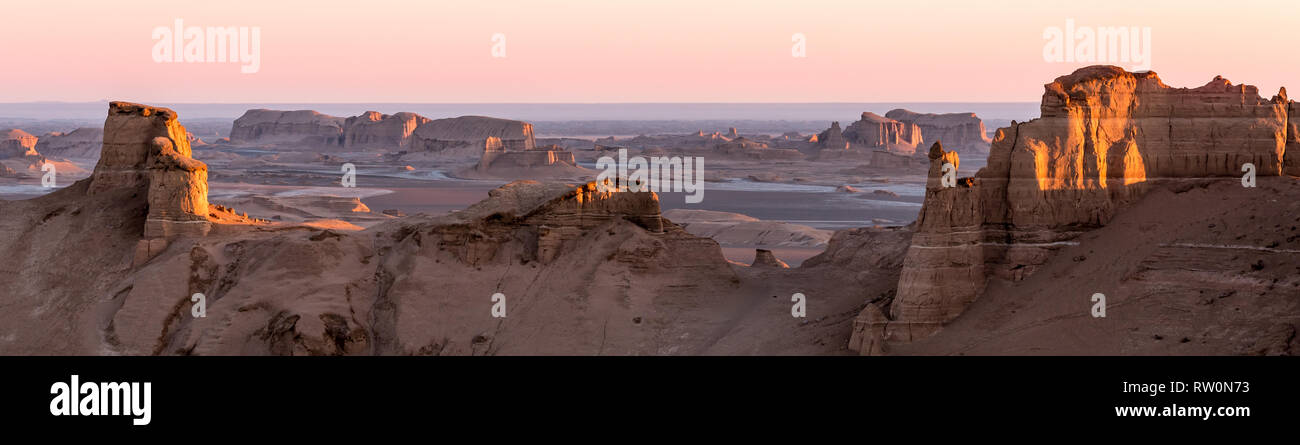 Panoramic view of sandy mountains in Kaluts desert, part of Dasht-e Lut desert during sunrise, Iran Stock Photo