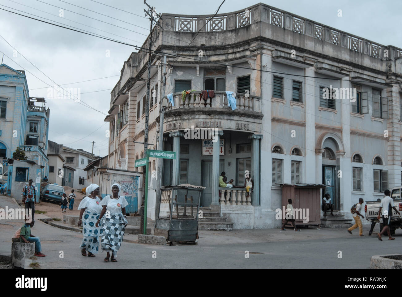 A nice view on a busy street  with people and interesting architecture in the Ghanaian city of Elmina. Stock Photo