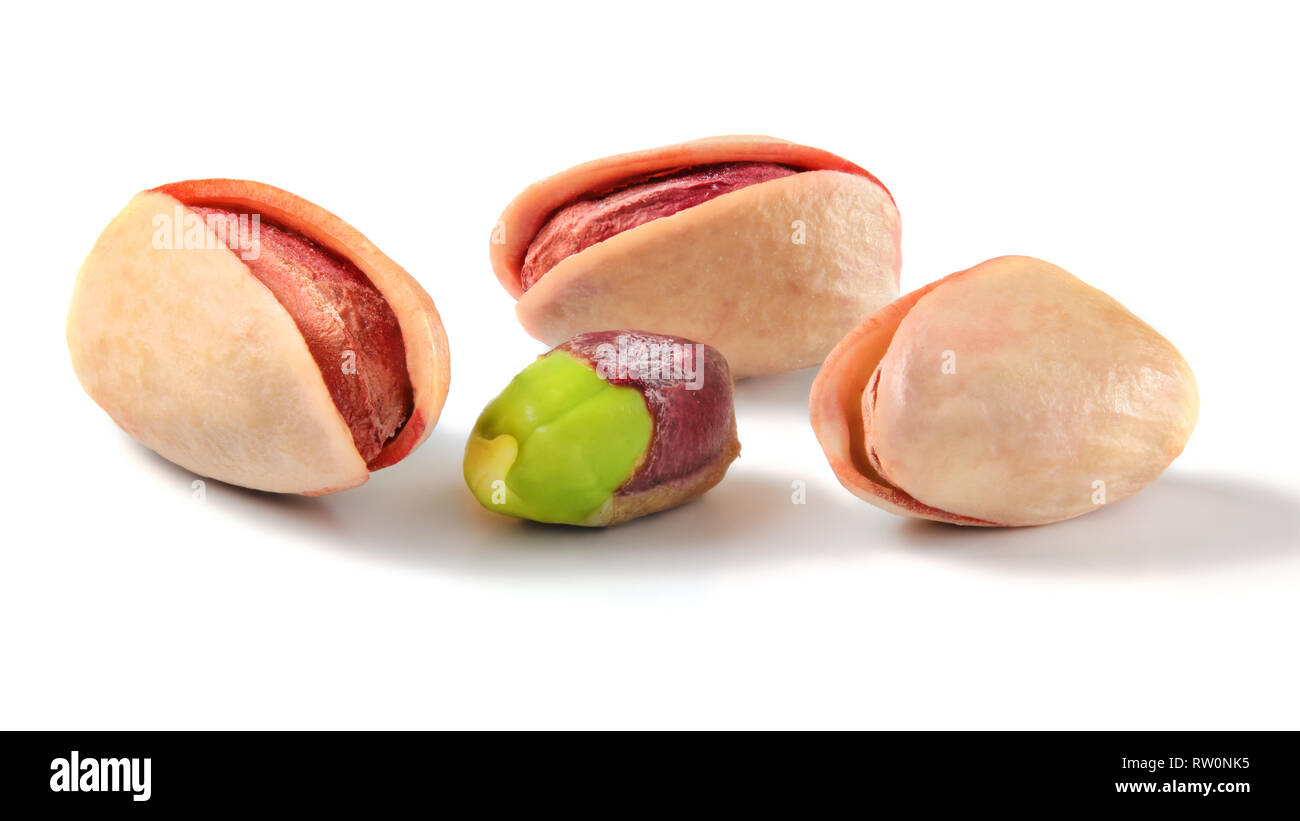Three roasted Turkish red pistachios, and one partially peeled green