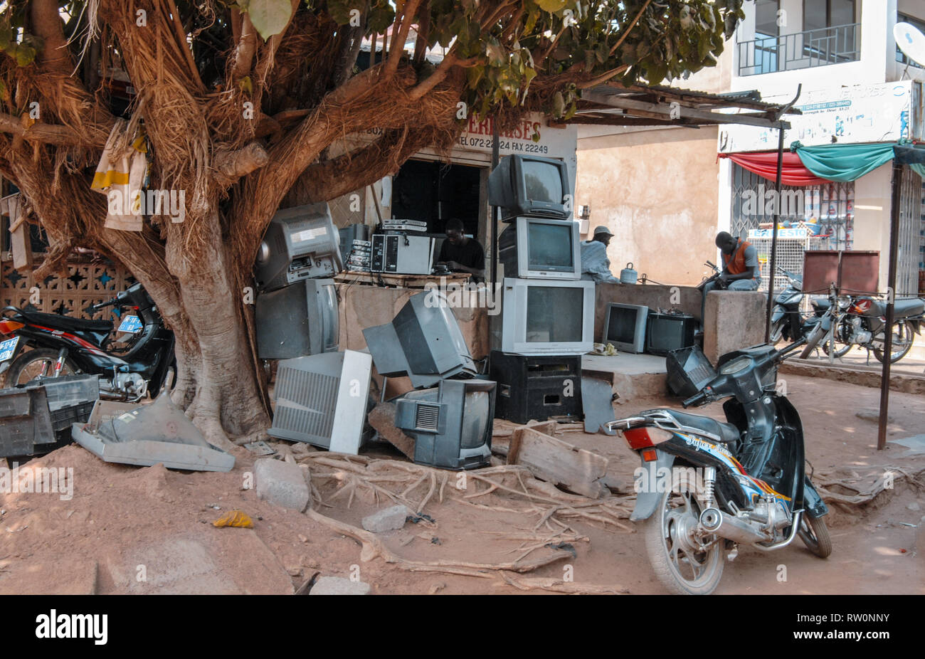 A pile of old tvs (television sets) in front of a tv repair shop in Bolgatanga, Ghana, West Africa Stock Photo