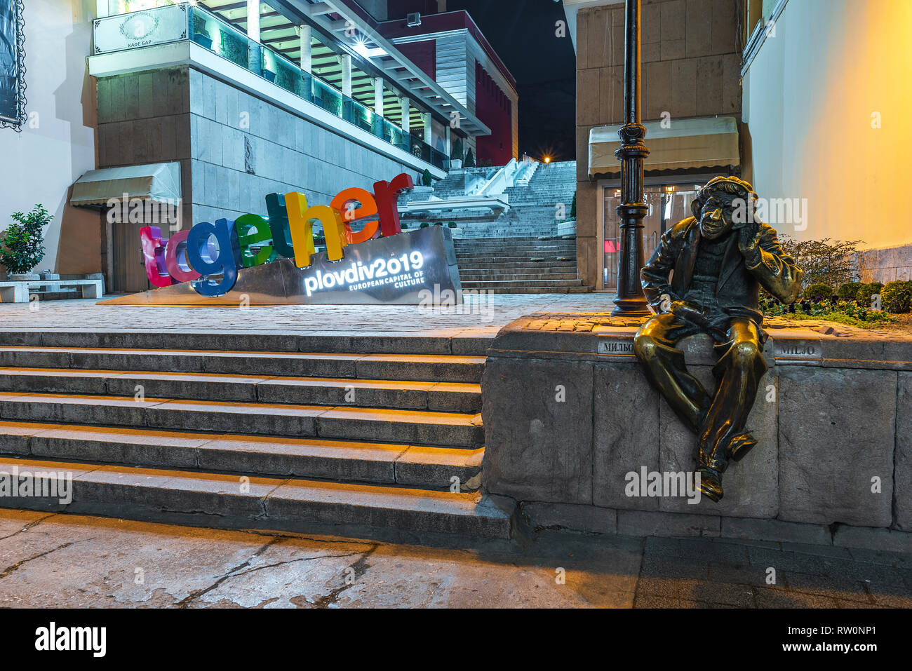 PLOVDIV CITY, BULGARIA - March 3 2019 - Night in the center of Plovdiv city- European Capital of Culture 2019 with Statue of Milyo the Crazy in front Stock Photo