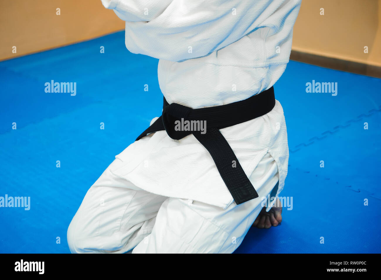 Aikido black belt on a white kimono Stock Photo - Alamy