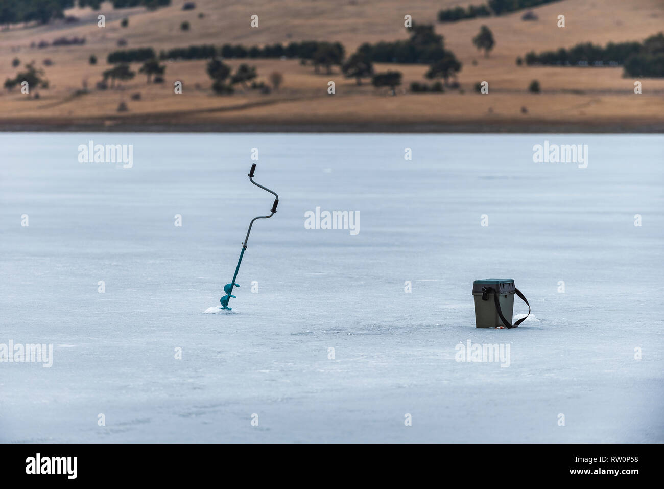 Ice drill tool. Drilling holes for fishing Stock Photo Alamy