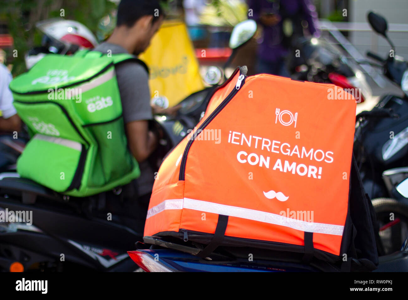 Lima, Peru - March 3 2019: Rappi, Uber eats and Glovo boxes in motorbikes. Competing brands for food delivery service. Sharing collaborative economy c Stock Photo