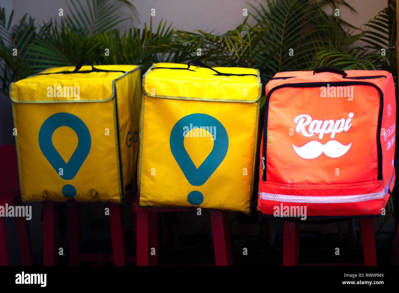 Lima, Peru - March 3 2019: Glovo and Rappi boxes outside a restaurant, food delivery service. Sharing economy concept. Stock Photo