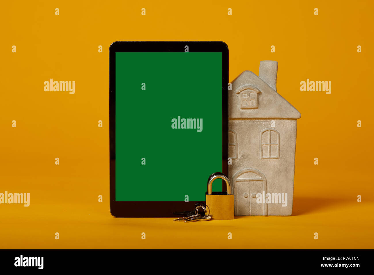 tablet screen lock with green screen on yellow background Stock Photo Alamy