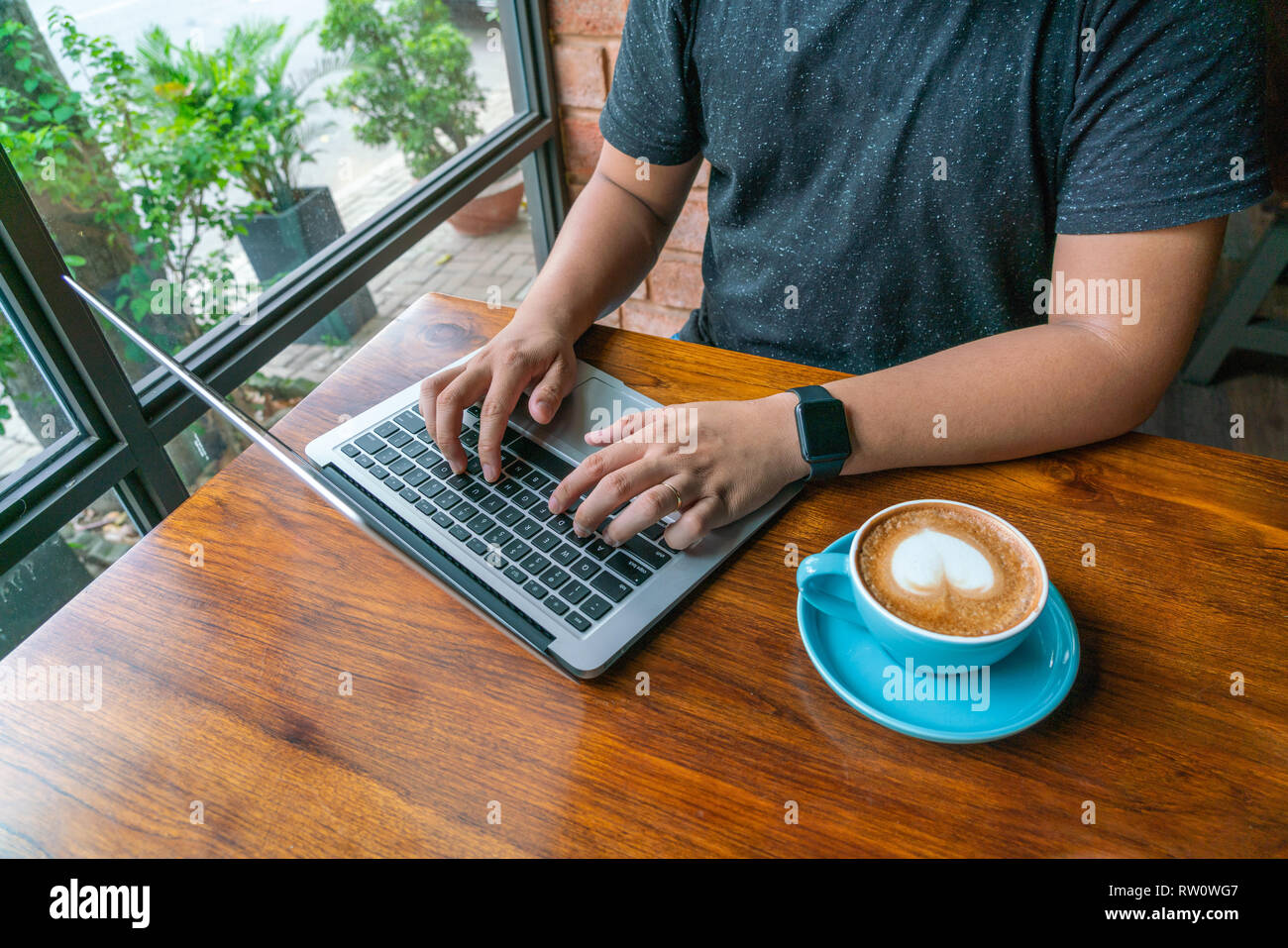 Young man in casual clothes using laptop Stock Photo