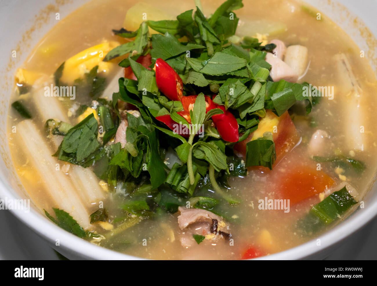 Cambodia, Phnom Penh, City Centre, Romdeng training restaurant spicy chicken pho soup Stock Photo