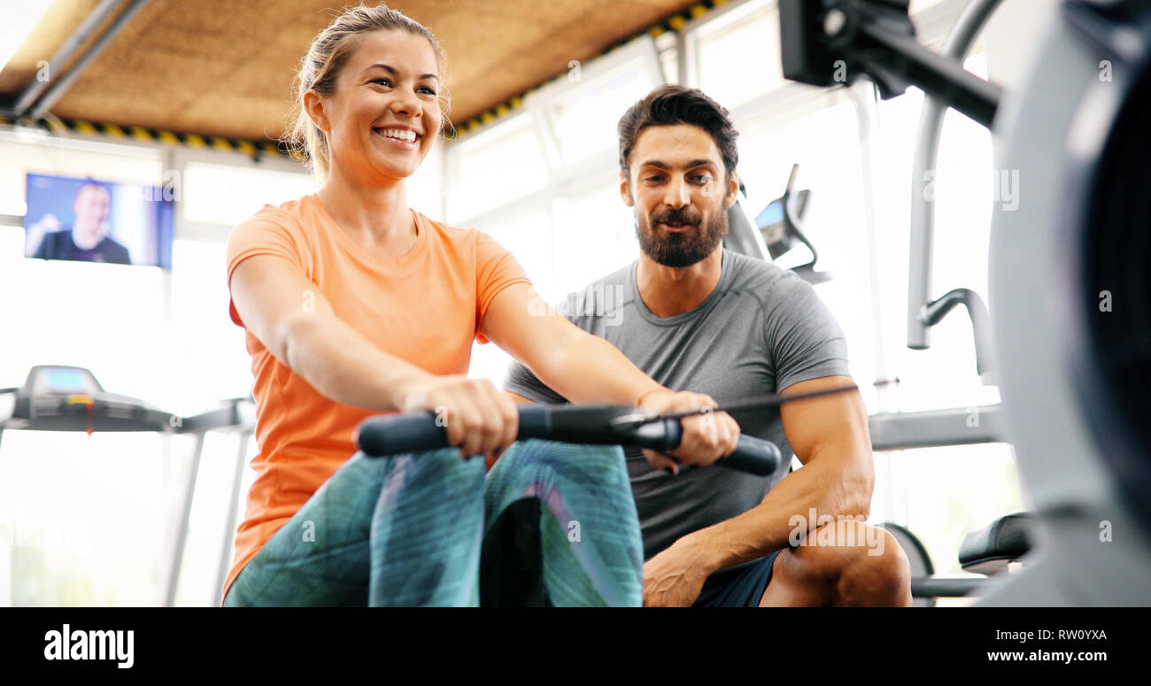 Personal trainer helping young woman reach goals Stock Photo - Alamy