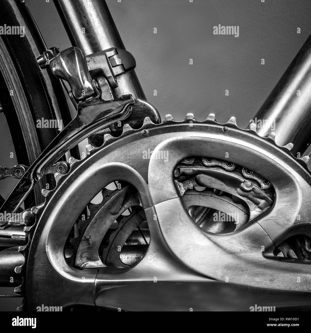 Fragment of a frame and parts of a road bike. The frame is made of titanium and there are