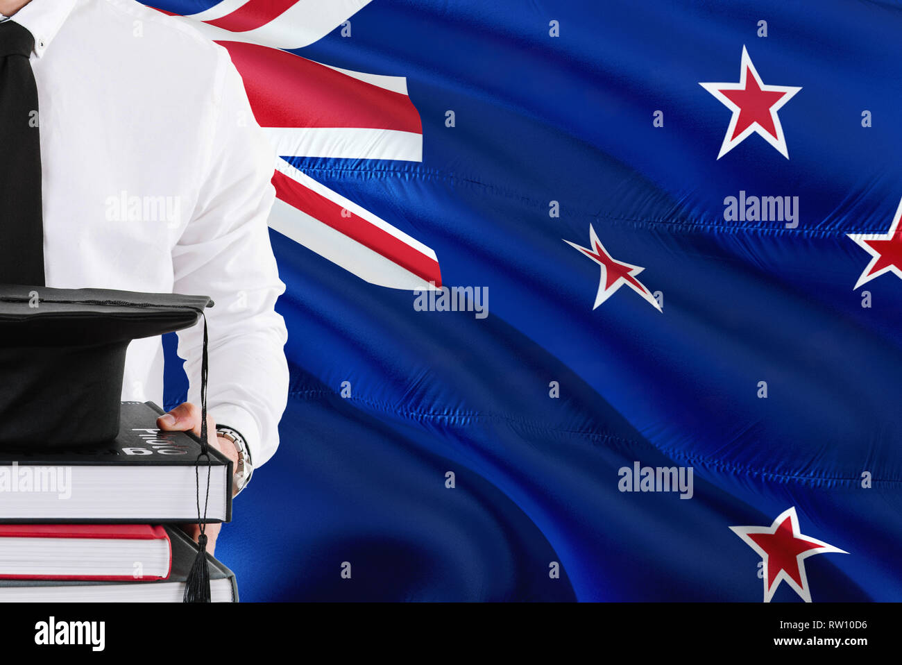 Successful student education concept. Holding books and graduation cap