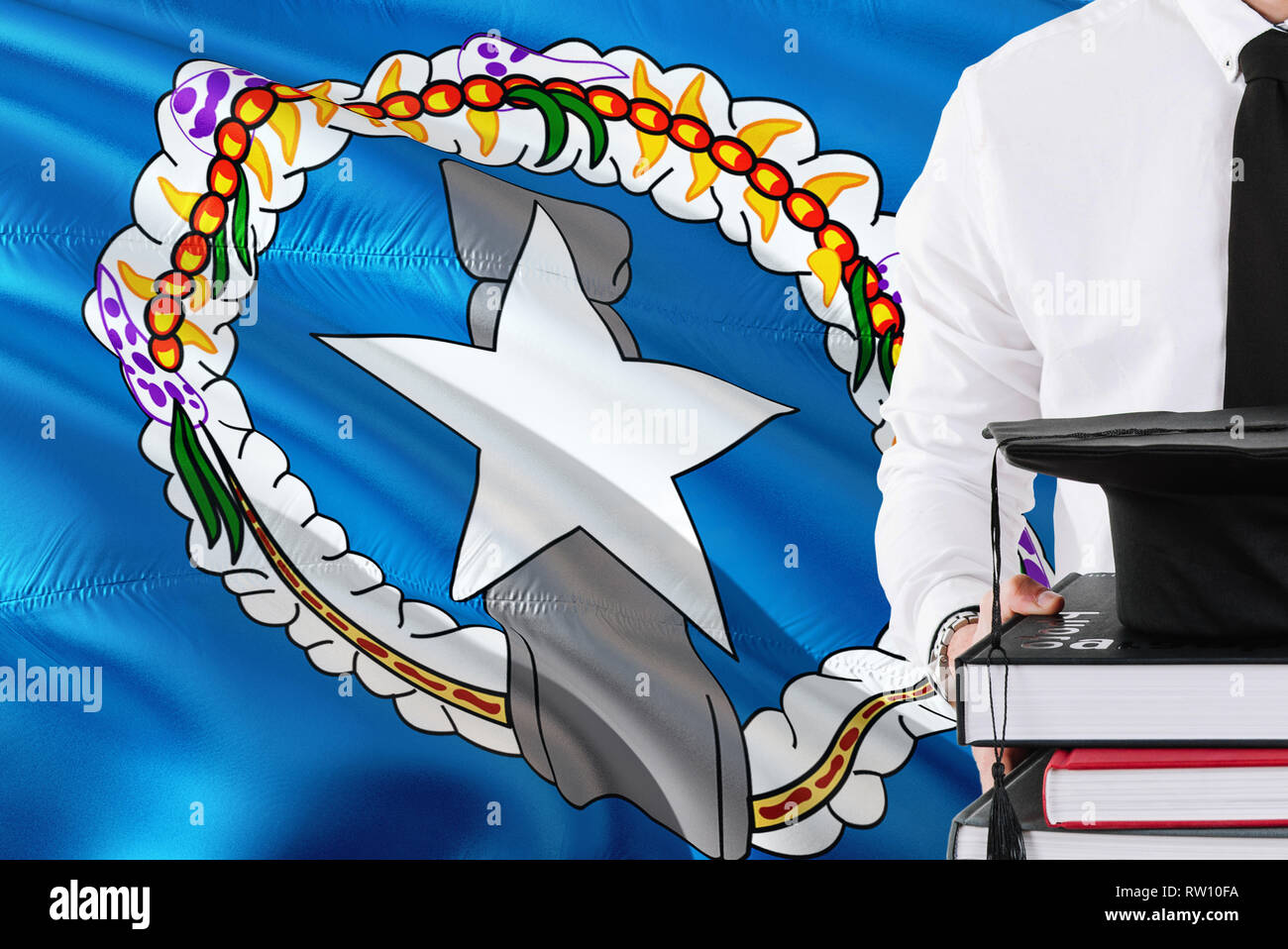 Successful student education concept. Holding books and graduation cap