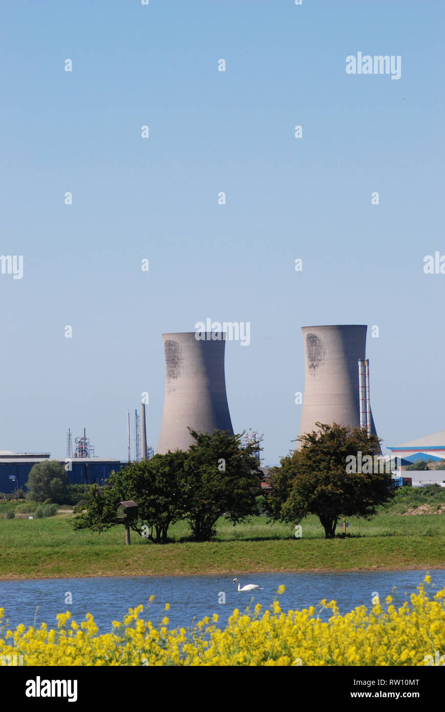A pair of cooling towers and countryside Stock Photo